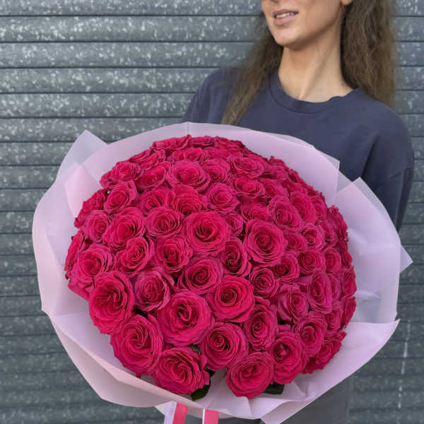 Large bouquet of hot pink roses wrapped in pale pink paper