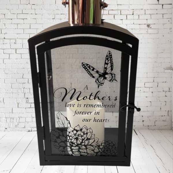 Black lantern with a candle and a Mother's Day memorial message
