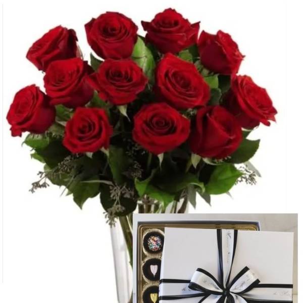 Bouquet of red roses in a clear vase with a box of chocolates