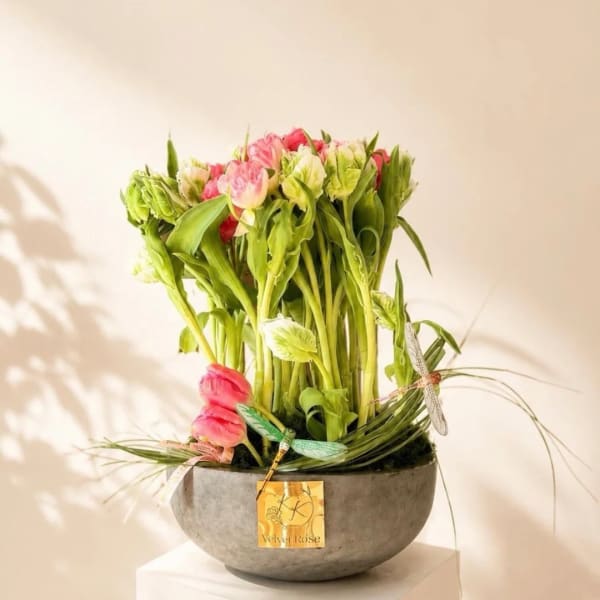 Pink and green floral arrangement in a round gray bowl