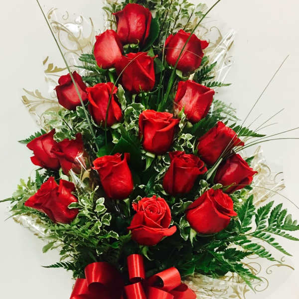 Tall bouquet of red roses with a red ribbon bow