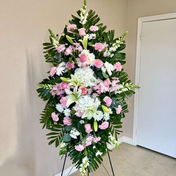 Standing floral spray with pink and white flowers on an easel