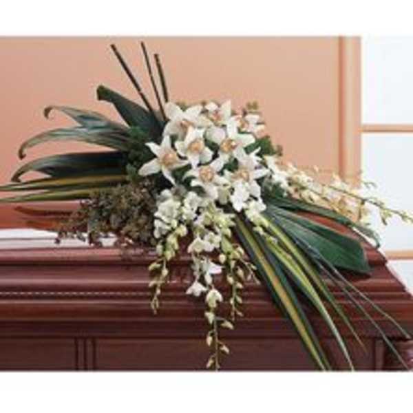 White floral spray on a wooden casket