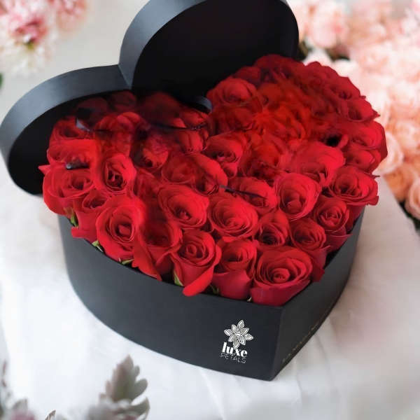 Heart-shaped box filled with red roses