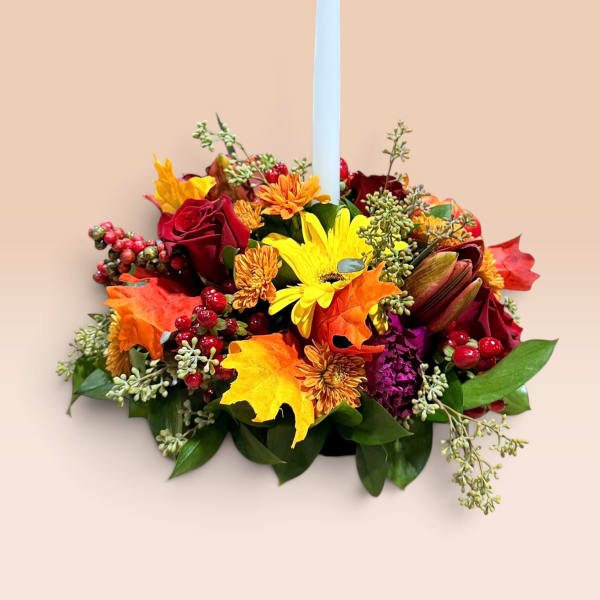 Autumn floral centerpiece with a tall white taper candle