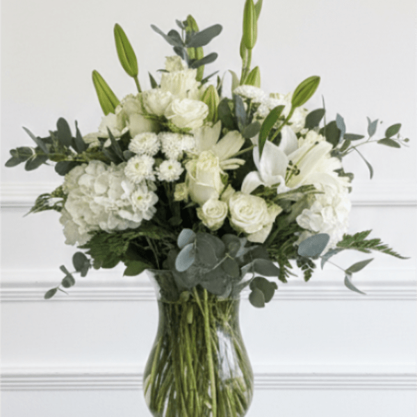 White floral arrangement in a clear glass vase
