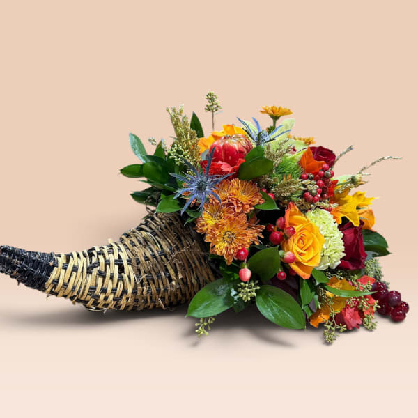 Horn-shaped basket filled with colorful flowers and berries