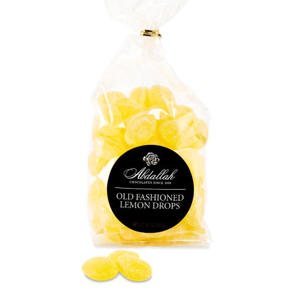 Bag of yellow old fashioned lemon drop candies with black round label and a few candies in front