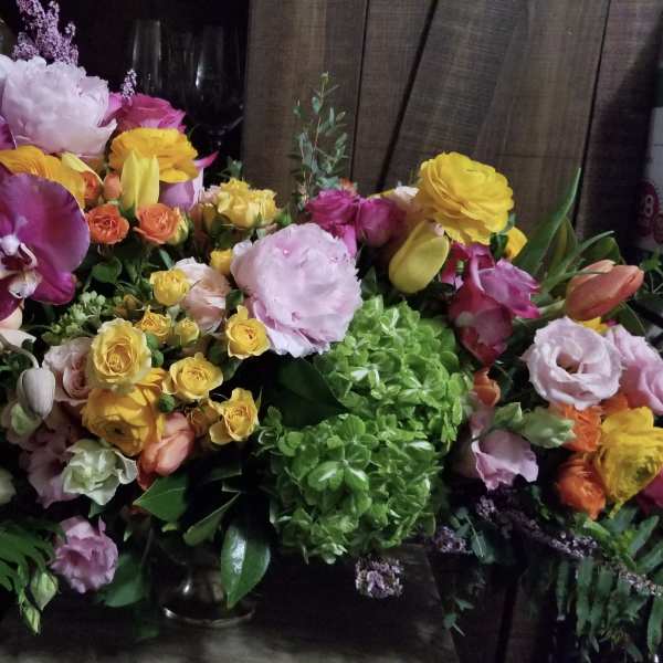 Mixed bouquet with purple orchids, yellow roses, and pink blooms