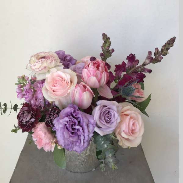 Pink and lavender floral arrangement in a silver vase