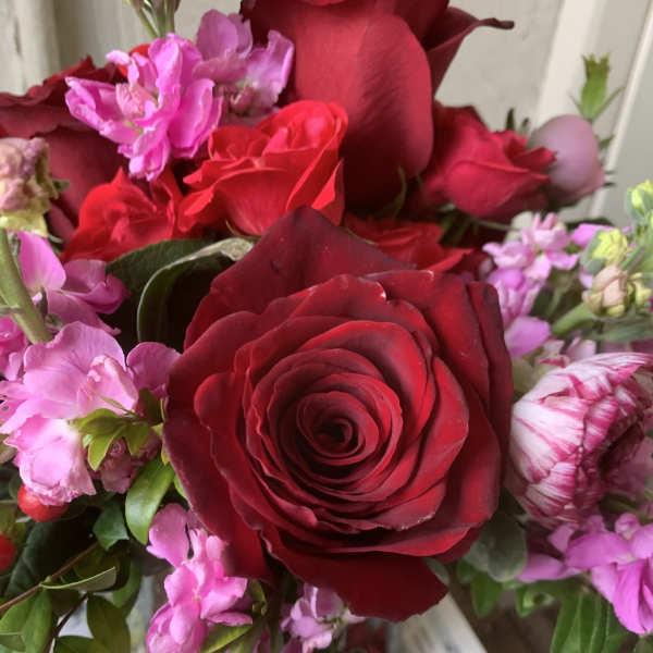 Close-up bouquet of red roses and pink flowers