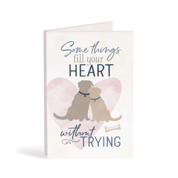Greeting card with two dogs and the text "Something fill your HEART without TRYING"