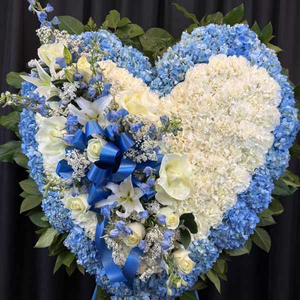 Heart-shaped blue and white floral standing spray with ribbon