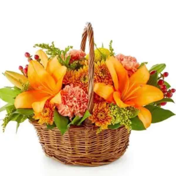 Basket of orange lilies and mixed flowers