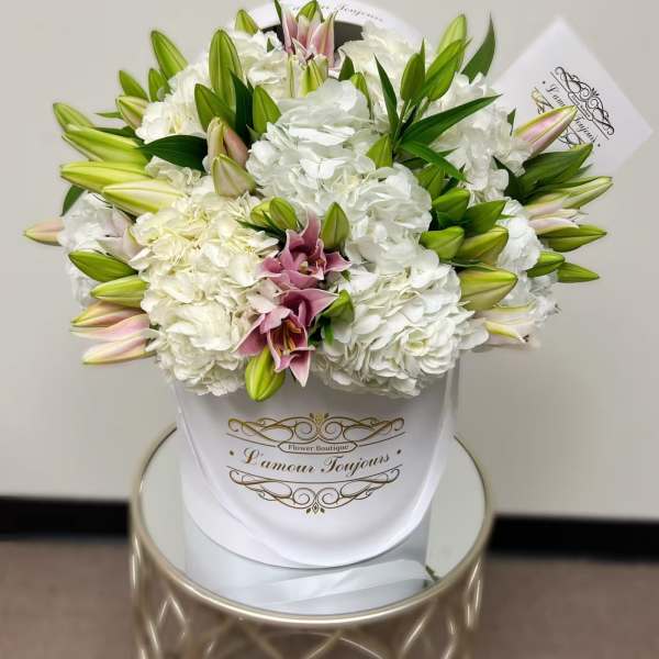 White hydrangea and lily bouquet in a white wrap
