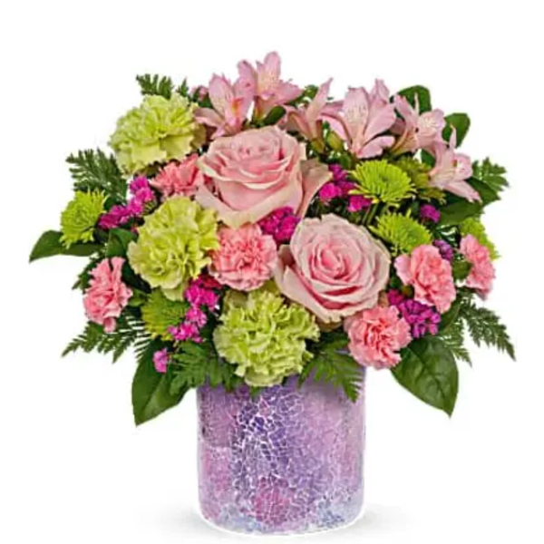 Pink roses and mixed blooms arranged in a purple vase