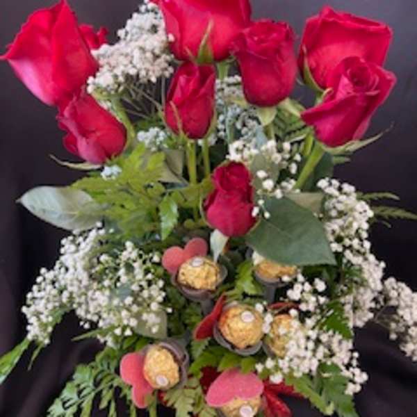 Bouquet of red roses with baby's breath and chocolates