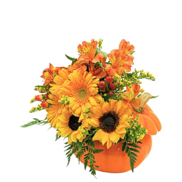 Orange and yellow floral arrangement in a pumpkin container