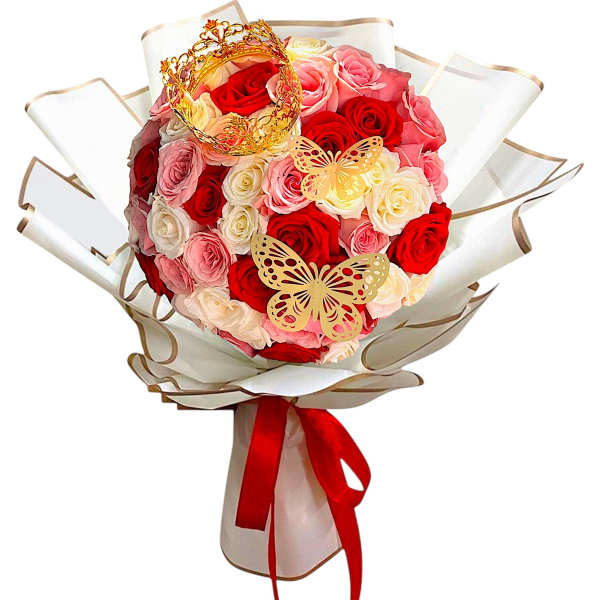 Bouquet of red, pink, and white roses with butterfly decorations and a red ribbon