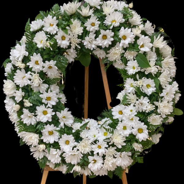 White daisy wreath on a wooden easel