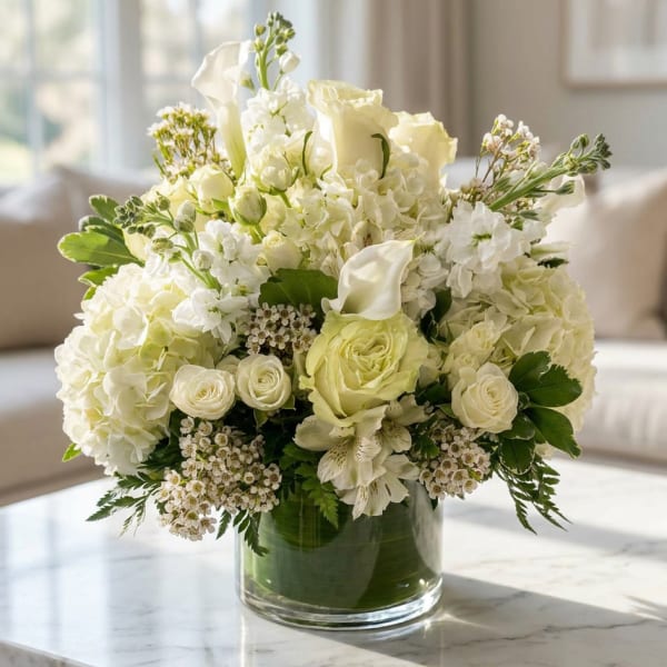 White floral arrangement in a clear glass vase