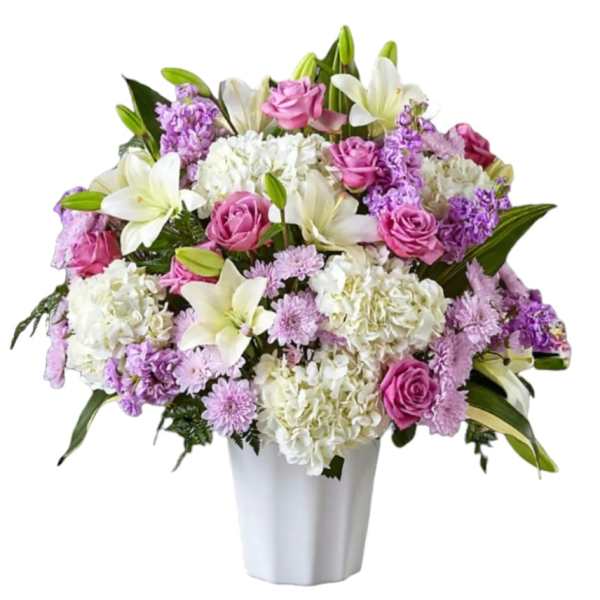 Pink roses and white lilies arranged in a white vase
