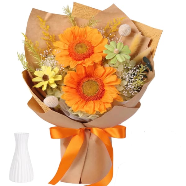 Bouquet of orange and yellow flowers wrapped in brown paper with an orange ribbon