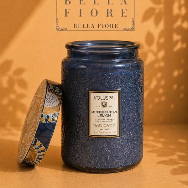 Blue scented candle in a decorative glass jar with lid