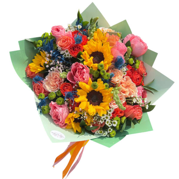 Mixed bouquet with sunflowers, pink roses, and coral blooms wrapped in green paper