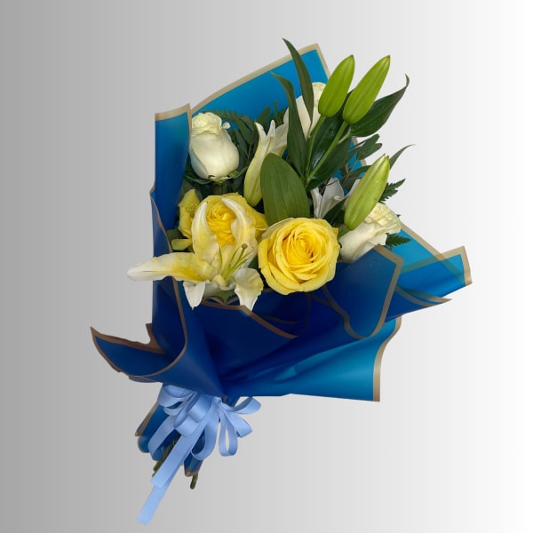 Bouquet of yellow roses and white lilies wrapped in blue paper