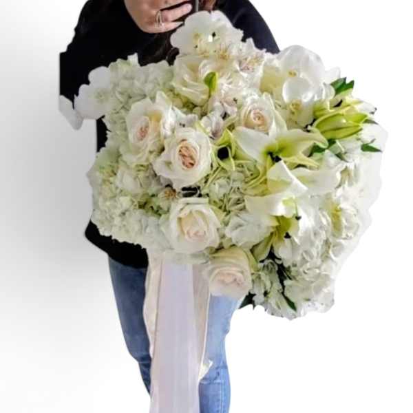 Large white bouquet with roses and lilies, tied with a long ribbon