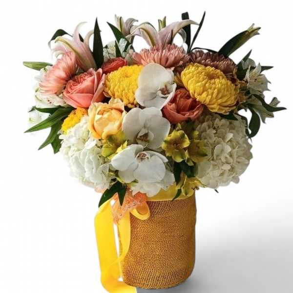 Mixed bouquet with orchids, roses, hydrangeas, and chrysanthemums in a burlap-wrapped vase