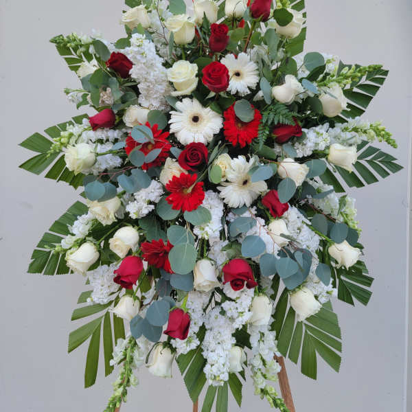 Large standing floral spray with red and white roses and white daisies