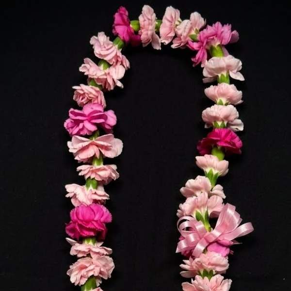 Pink flower lei on a black background