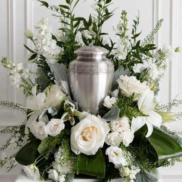 White floral funeral urn arrangement with roses and lilies