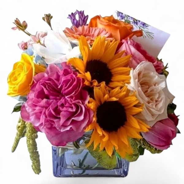 Mixed bouquet of roses and sunflowers in a blue glass vase
