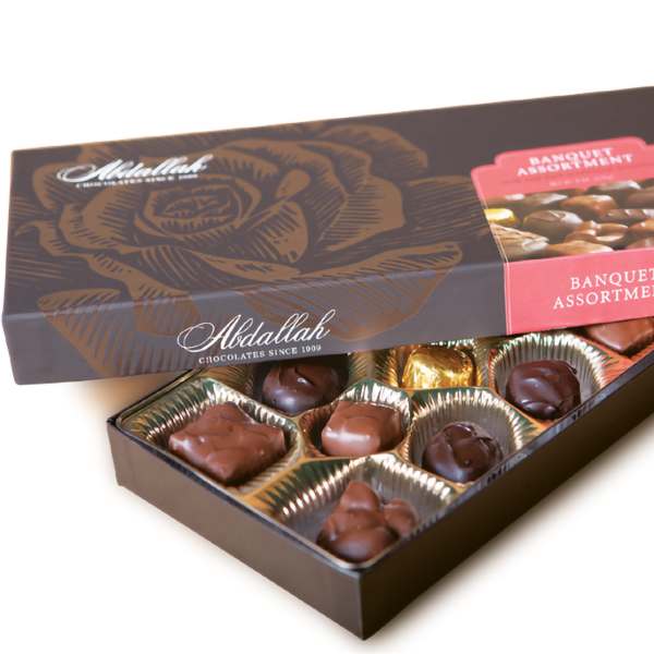 Open box of assorted chocolates with a matching lid