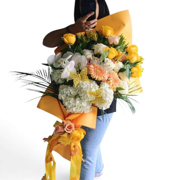 Large bouquet of yellow and white flowers with orange wrapping
