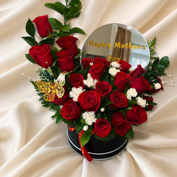 Beautiful design with mirror, Happy Mother's Day phrase, natural roses, carnations, and golden butterfly