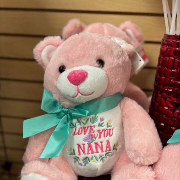 Pink teddy bear with a teal ribbon and "Love You Nana" on its belly