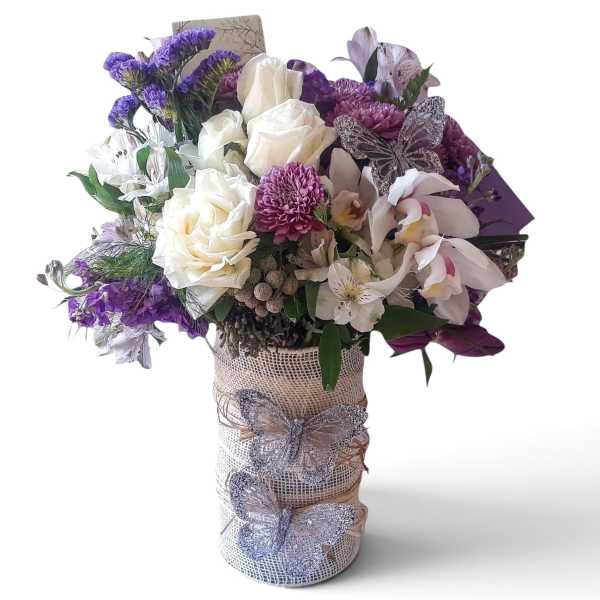 Bouquet of white roses and purple flowers in a wrapped vase