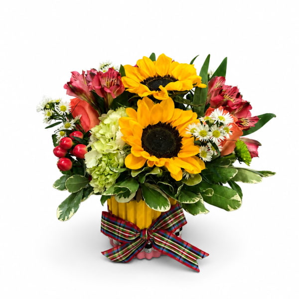 Bouquet of sunflowers, pink alstroemeria, and white daisies in a yellow container