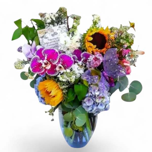 Mixed bouquet with orchids, sunflowers, hydrangeas, and a glass vase