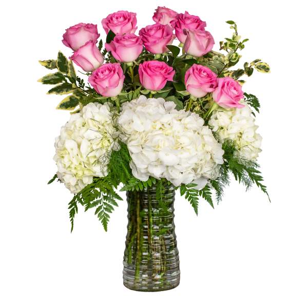 Pink roses and white hydrangeas in a glass vase