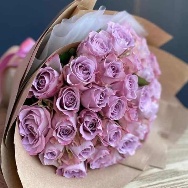 Bouquet of lavender roses wrapped in brown paper