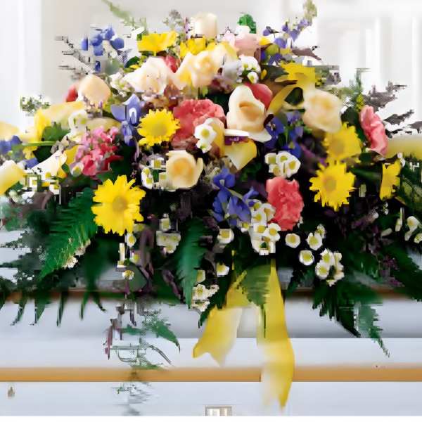 Large colorful floral arrangement with yellow, pink, white, and blue flowers