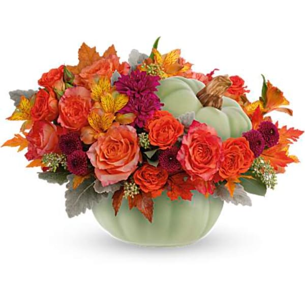 Autumn floral arrangement in a pale green pumpkin vase