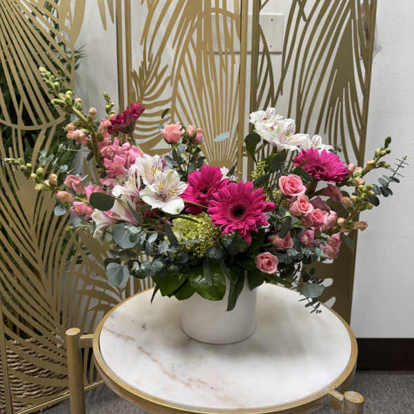 Pink and white mixed flower arrangement in a white vase