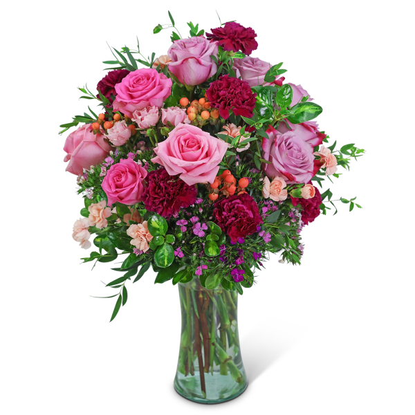 Pink and magenta rose bouquet in a clear glass vase