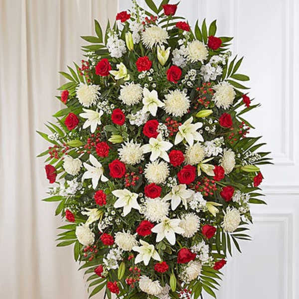 Standing floral spray with red roses, white lilies, and white chrysanthemums